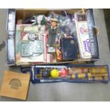 A box of assorted items including playing cards, medals, commemorative crowns, plastic animals,