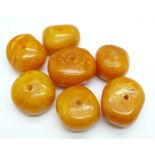 Seven butterscotch amber beads, 60g