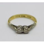 An 18ct gold, platinum set, two stone diamond ring, 1.9g, H