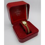 A lady's 9ct gold cased Omega wristwatch on a 9ct gold bracelet strap, with box