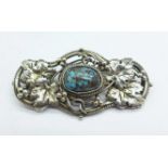 An Arts and Crafts turquoise set brooch with yellow metal pin, circa 1900, 28mm x 53mm, tests as