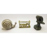 A bronze figure of a girl, a brass letter rack and a metal model of a snail