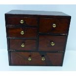 A modern miniature set of wooden drawers with inlaid marquetry transfer decoration, 18.25cm