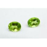 Two unmounted peridots, approximately 4ct total weight and each approximately 9mm x 7mm