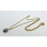 A 14ct gold and black pearl pendant on a 1/20th 14ct rolled gold chain