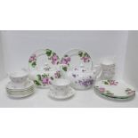 An Aynsley English Rose teapot and six 20.5cm plates, an Aynsley English Violets teapot and six