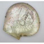 A large oyster shell, the mother of pearl with carved scene of a fisherwoman mending the nets with