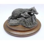 A hallmarked silver filled figure group, two badgers on a wooden stand, hallmarked Parkin, Sheffield