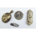 A white metal locket, a/f, (tests as silver), an 1887 shilling brooch, a Victorian silver brooch,