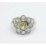 A platinum and diamond cluster ring, with 1ct yellow diamond centre stone surrounded by eight rose
