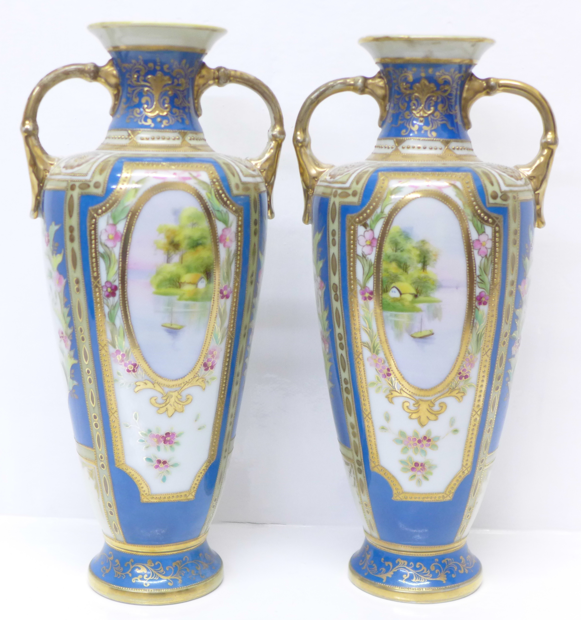 A pair of Noritake vases with gilded decoration and painted panels over a blue ground, 30.5cm