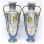 A pair of Noritake vases with gilded decoration and painted panels over a blue ground, 30.5cm