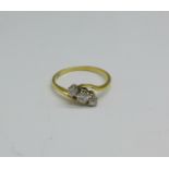 An 18ct gold, three stone diamond crossover ring, 2.7g, R