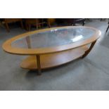 A teak and glass topped oval coffee table