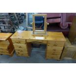 A pine dressing table and a pair of bedside tables