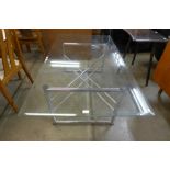 A chrome and glass topped x-frame coffee table