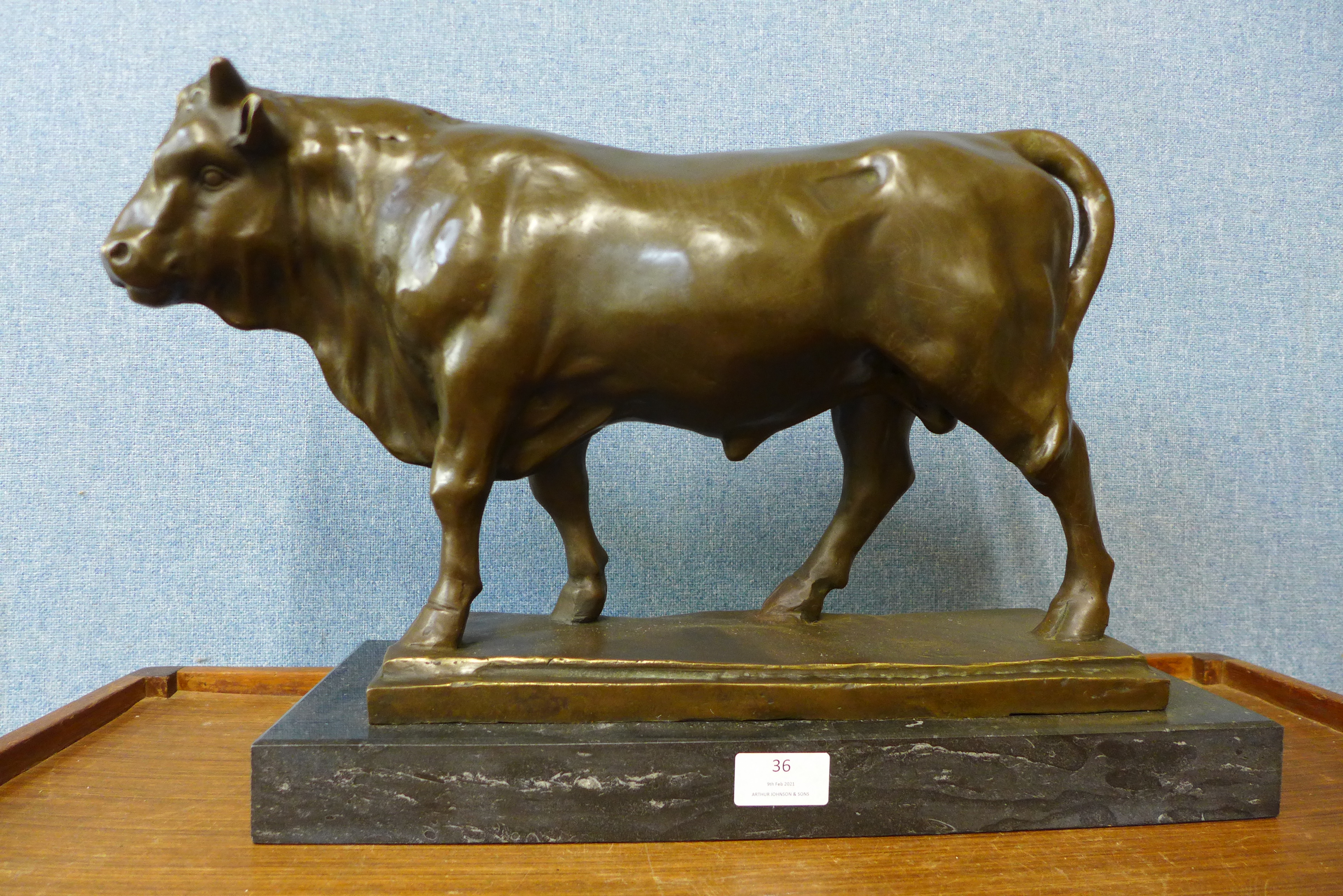 A large French style bronze figure of a bull, manner of Antoine Louis Barye, on black marble plinth,