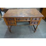 An early 20th Century carved oak linenfold writing desk, 77cms h, 107cms w, 61cms d