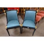 A pair of ebonised and parcel gilt swan chairs, manner of M. Jansen