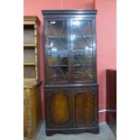 A George III style mahogany astragal glazed splay front freestanding corner cabinet, 195cms h, 89cms