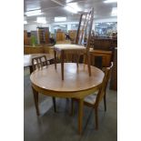 A Nathan teak extending dining table and two sets of four teak dining chairs