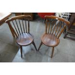 A pair of early 20th Century beech penny seat kitchen chairs