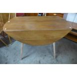 An Ercol Blonde beech and elm drop-leaf table, 72cms h, 113cms l, 63cms w