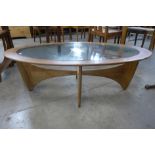 A G-Plan Astro teak and glass topped oval coffee table