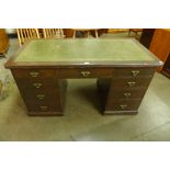A Victorian stained pitch pine and green leather topped pedestal desk, 74cms h, 137cms w, 69cms d