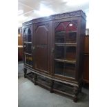 A carved oak three door bookcase