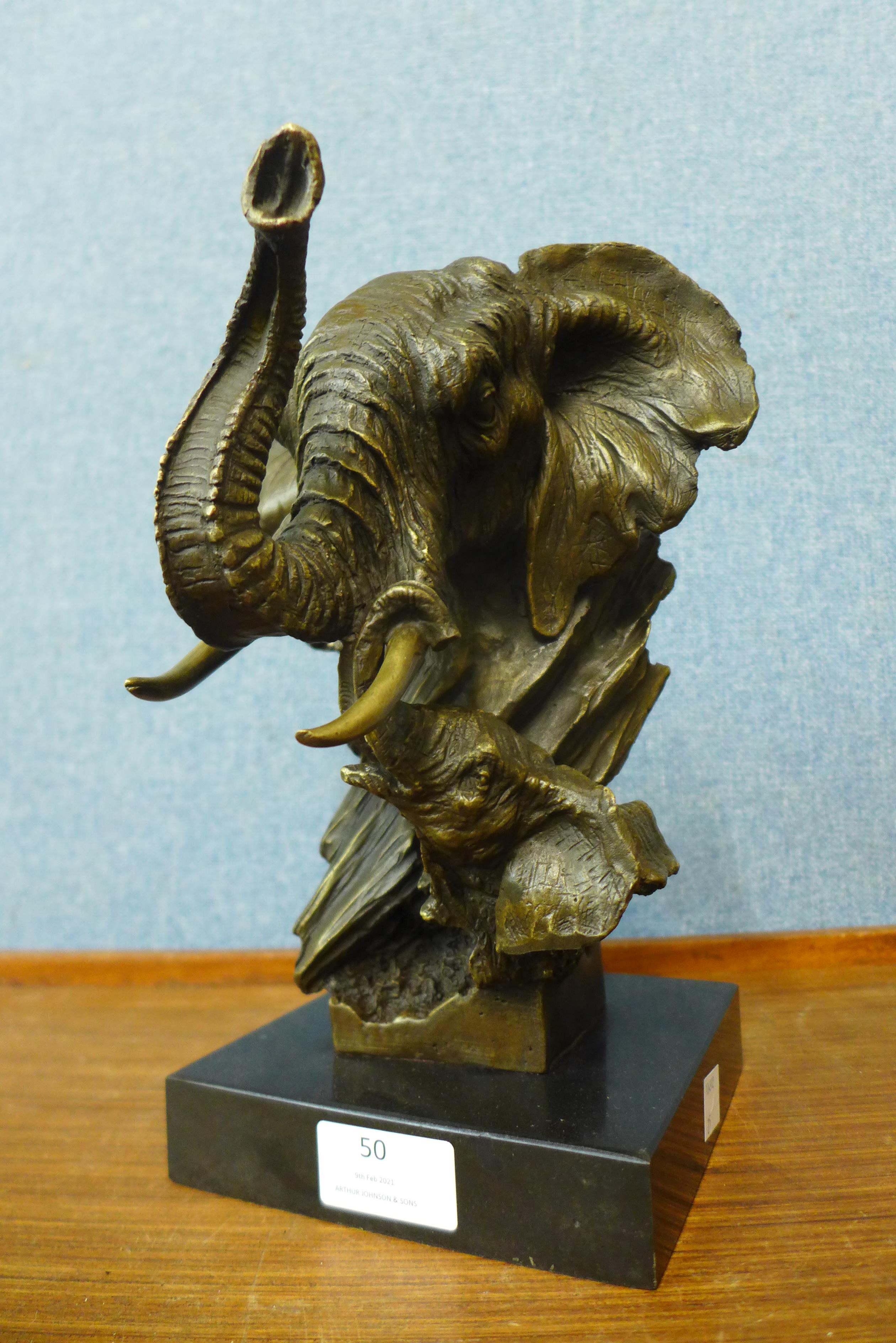 A French style bronze elephant bust, on black marble socle, 28cms h