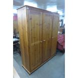 A pine three door wardrobe