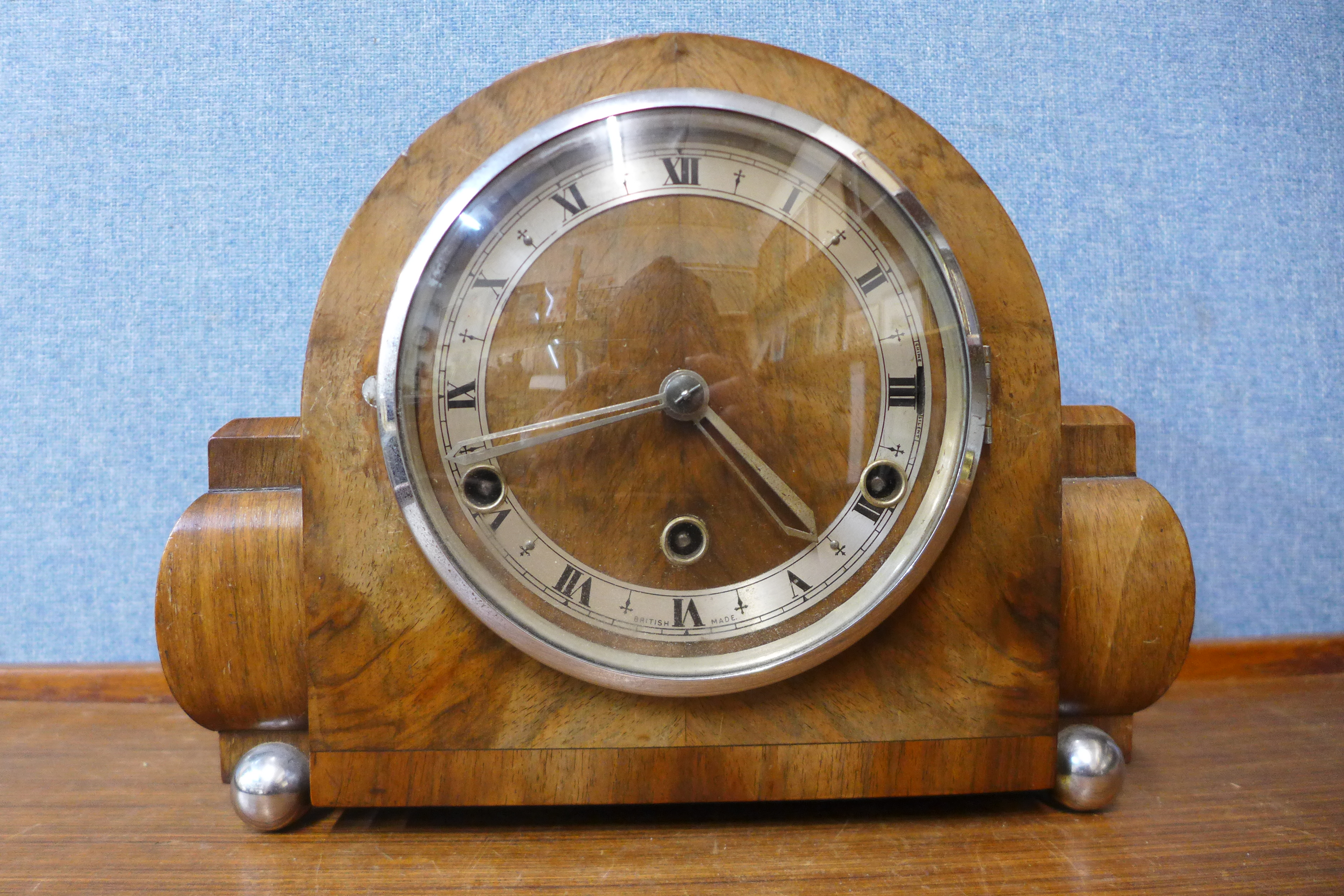 A walnut and chrome mantel clock, 22cms h