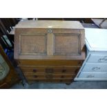 A 17th Century style oak geometric moulded bureau