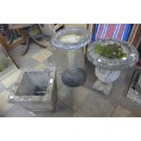 A concrete bird bath, a concrete campana shaped garden urn and one other