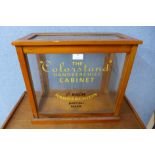 A beech counter top display cabinet, bearing The Colorstand Handkerchief Cabinet inscription,