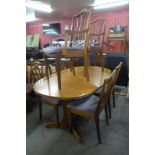 A teak extending dining table and six chairs