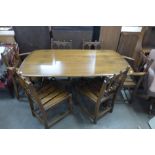 An Ercol Golden Dawn elm and beech eight piece dining suite