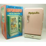 A 1960's battery operated tin-plate toy refrigerator, boxed