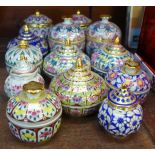 A collection of thirteen Bencharong hand painted porcelain lidded jars, including two pairs, Spink
