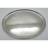 An oval silver tray, Birmingham 1923, Synyer & Beddoes, with monogram, 356g, 28.5cm