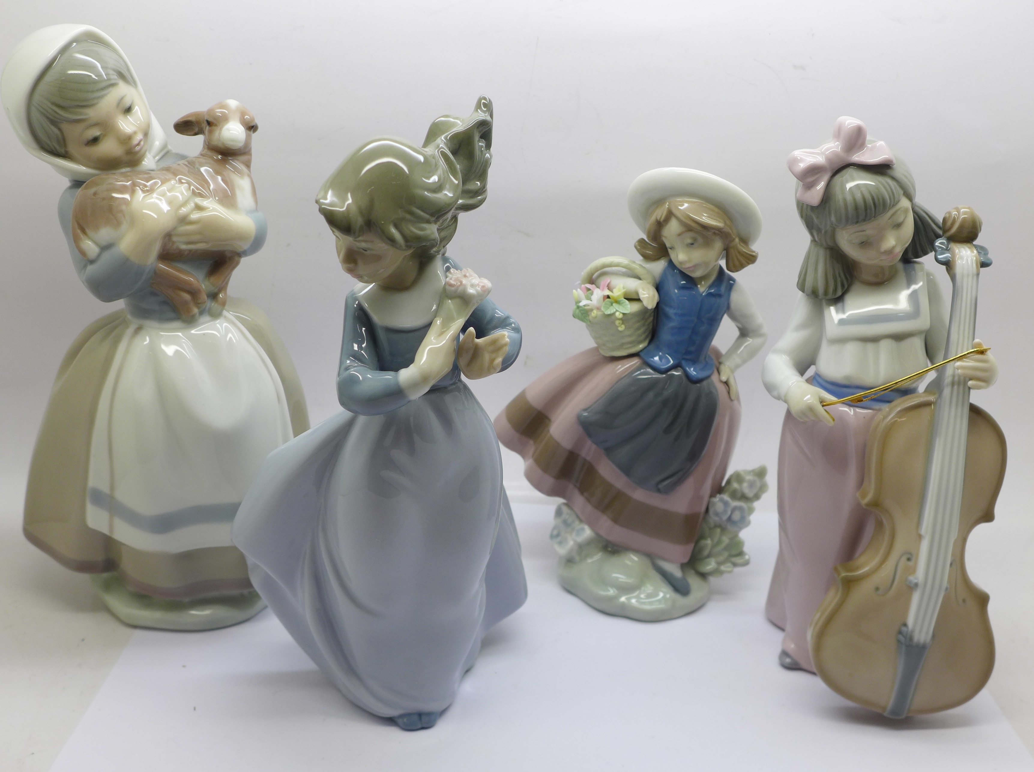 Three Nao figures and a Lladro figure