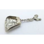 A silver shovel caddy spoon, import mark for London 1913