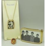 Beatles jewellery; a ring, belt buckle and a pendant and chain