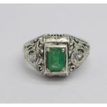 A white metal, emerald and diamond three stone ring, 4.2g, O, emerald approximately 7mm x 5mm
