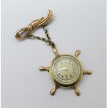 A 10k rolled gold brooch watch in the form of a ship's wheel, case worn, lacking winding crown