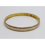 A 9ct three colour gold bangle, 4.3g