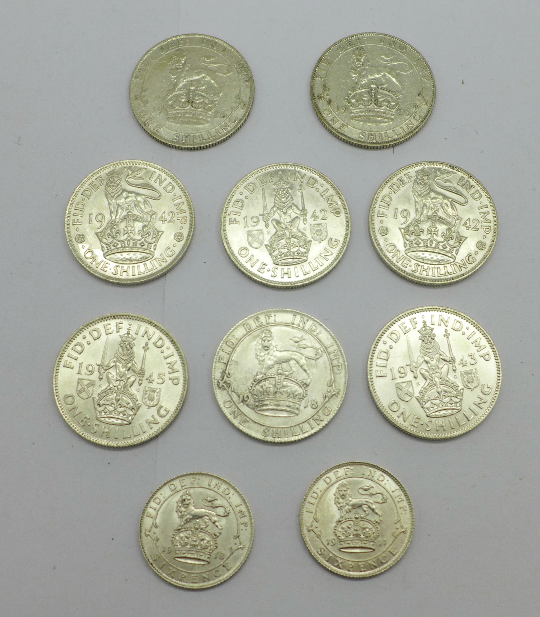 Eight one shilling coins;- 1918, 2x 1926, 3x 1942, 1943 and 1945, and two sixpence coins, 1911 and