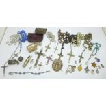 A collection of religious items; seven rosaries, two with pouches, crucifixes, medallions, Holy