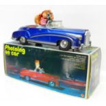 A Chinese battery operated 'Photoing on Car' mystery action tin plate car, 30cm, boxed
